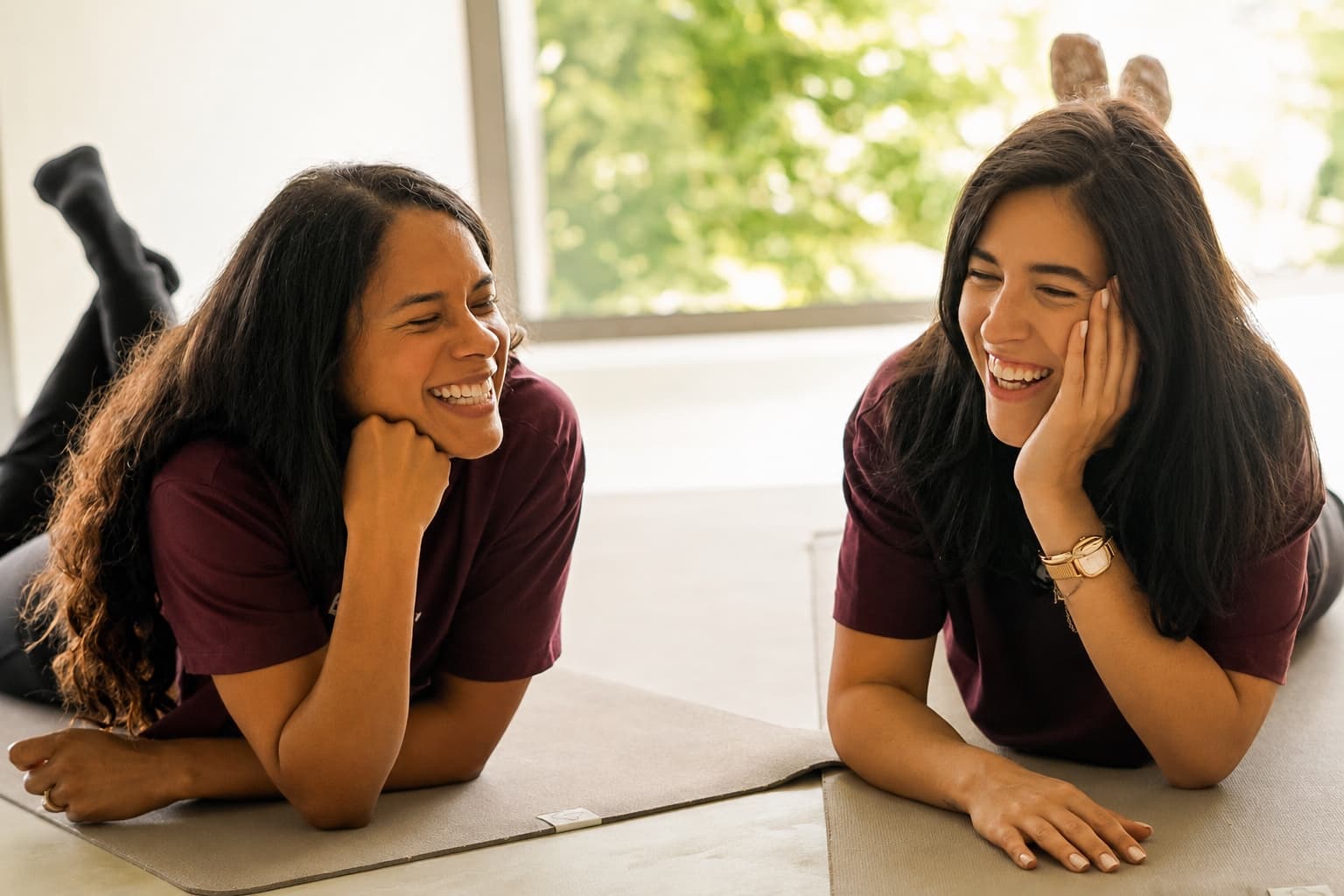 Deux coachs Reform souriantes, allongées sur des tapis de Pilates